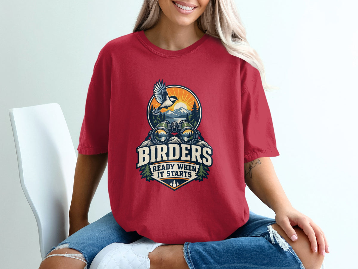 Red t-shirt with a graphic of binoculars and the text "Birders Ready When It Starts".
