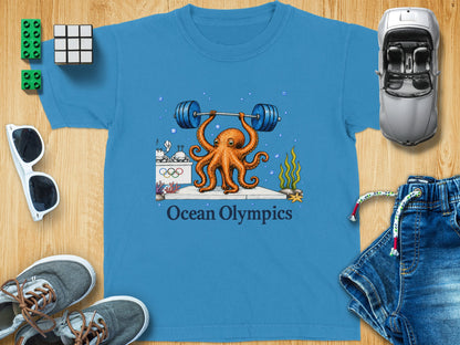 Blue t-shirt with an octopus lifting a barbell, featuring "Ocean Olympics" text.