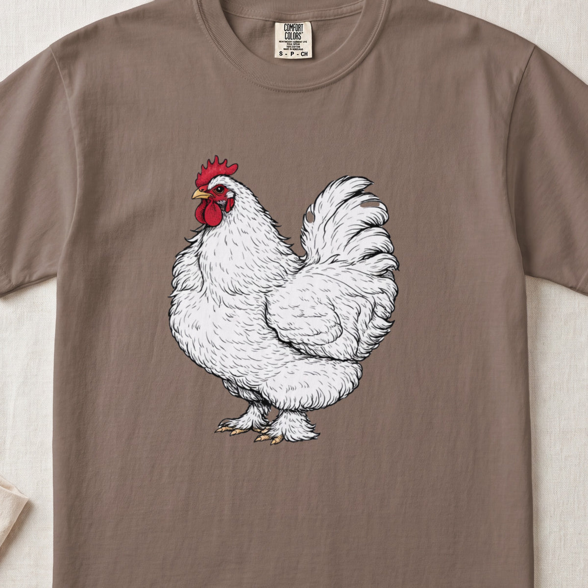 A brown crewneck t-shirt featuring a detailed white rooster graphic on the chest.