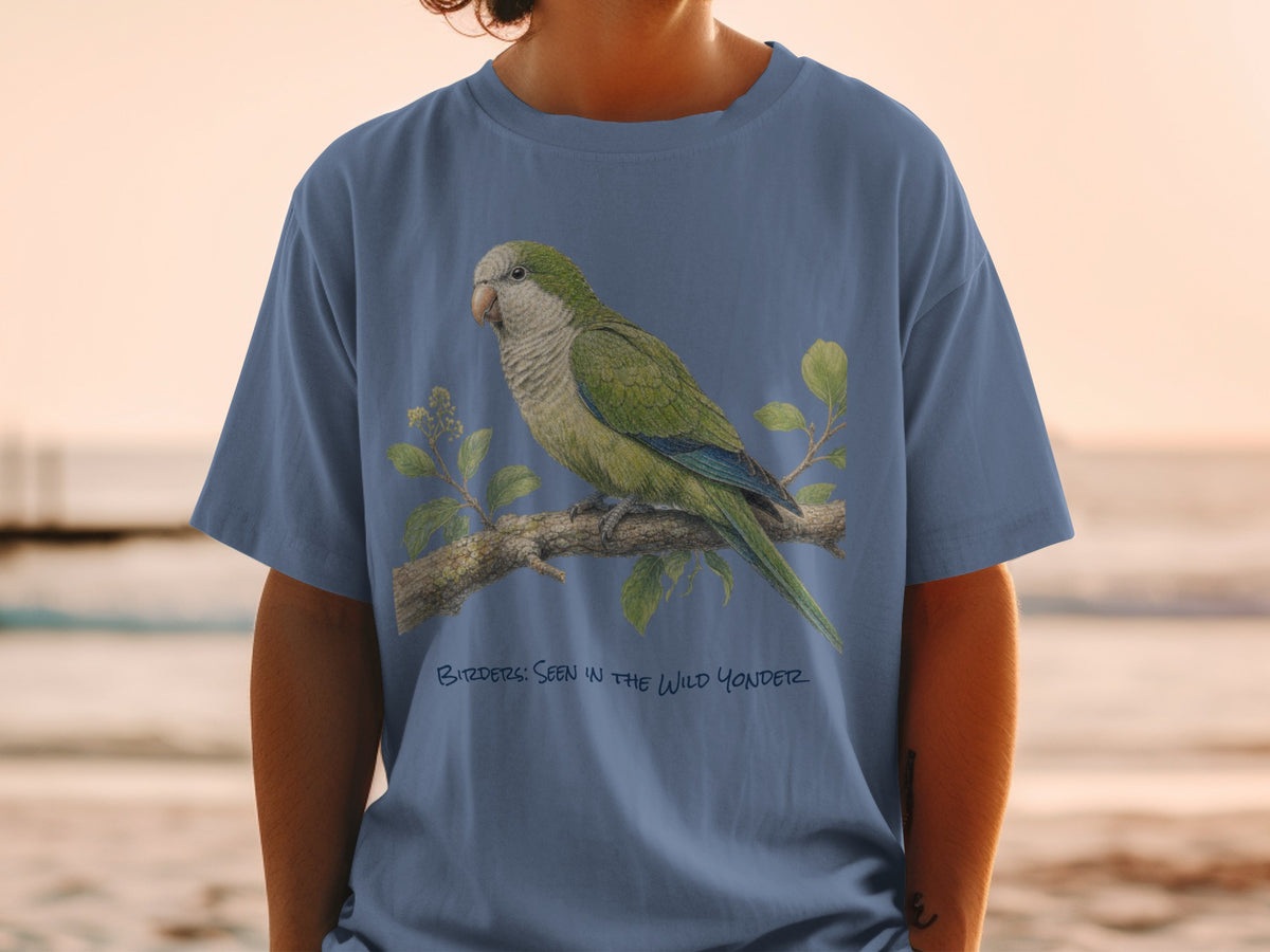 Blue t-shirt with illustration of a green parrot on a branch and text "Birders: Seen in the Wild Yonder".