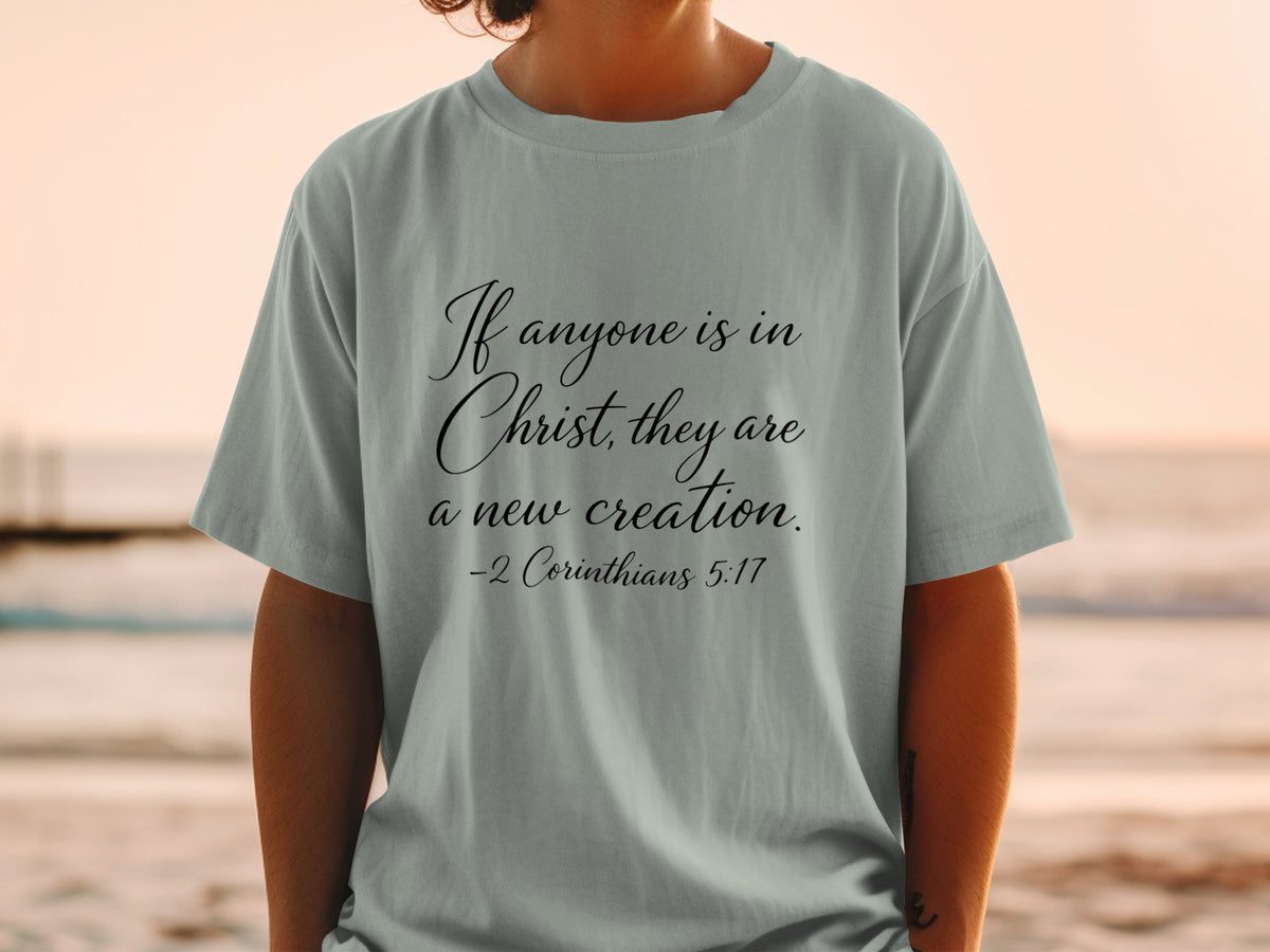 Light gray t-shirt with "If anyone is in Christ, they are a new creation. -2 Corinthians 5:17" printed on it.