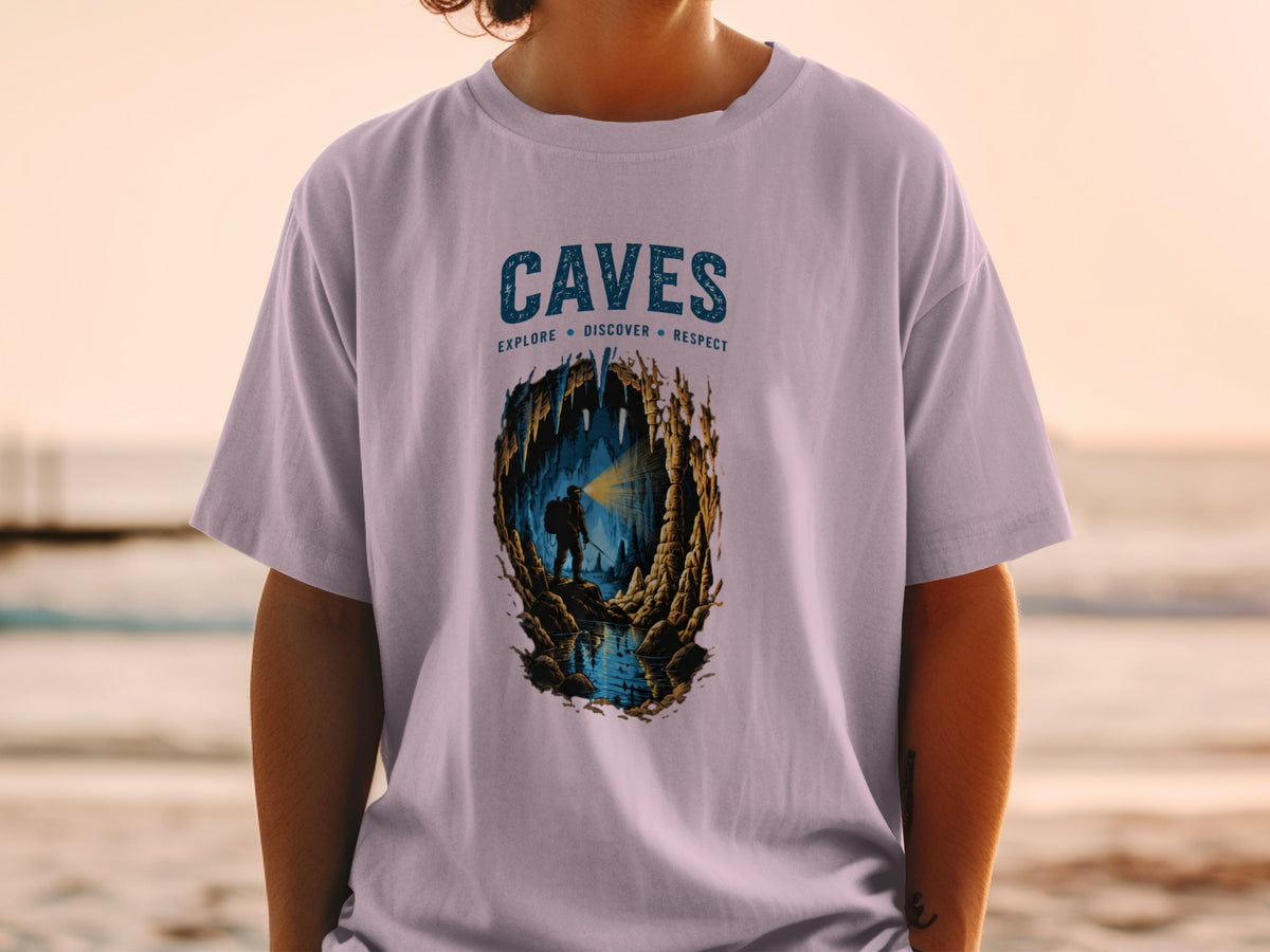 T-shirt graphic with the word "CAVES" and a spelunker exploring a cave with water.