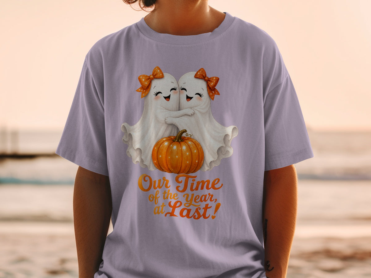 Two cute ghosts hug a pumpkin with text "Our Time of the Year, at Last!"