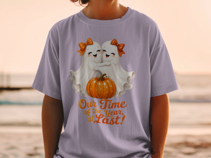 Two cute ghosts hug a pumpkin with text "Our Time of the Year, at Last!"