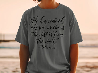 Dark gray t-shirt with black text: "He has removed our sins as far as the east is from the west." -Psalm 103:12