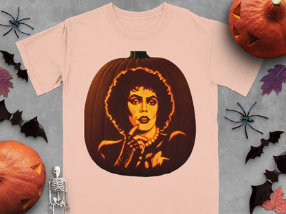 Peach-colored t-shirt featuring a lit jack-o-lantern carved with a portrait of Frank-N-Furter from Rocky Horror.