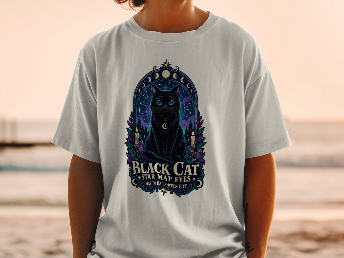 T-shirt graphic of a black cat with starry eyes, surrounded by moons, candles, and crystals.