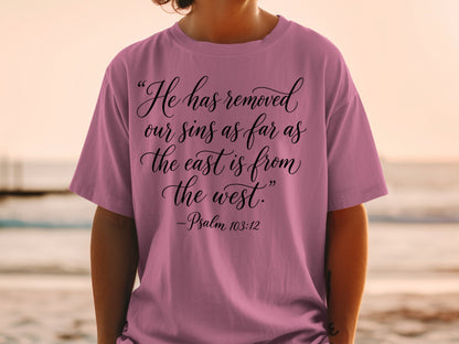 Pink t-shirt with "He has removed our sins as far as the east is from the west. -Psalm 103:12"