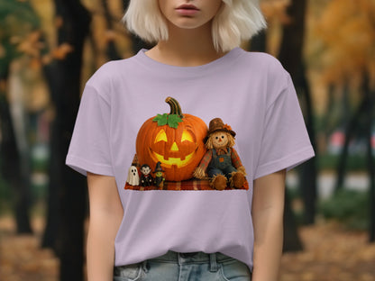 Halloween graphic on a light purple t-shirt featuring a jack-o'-lantern, scarecrow, and spooky figures.