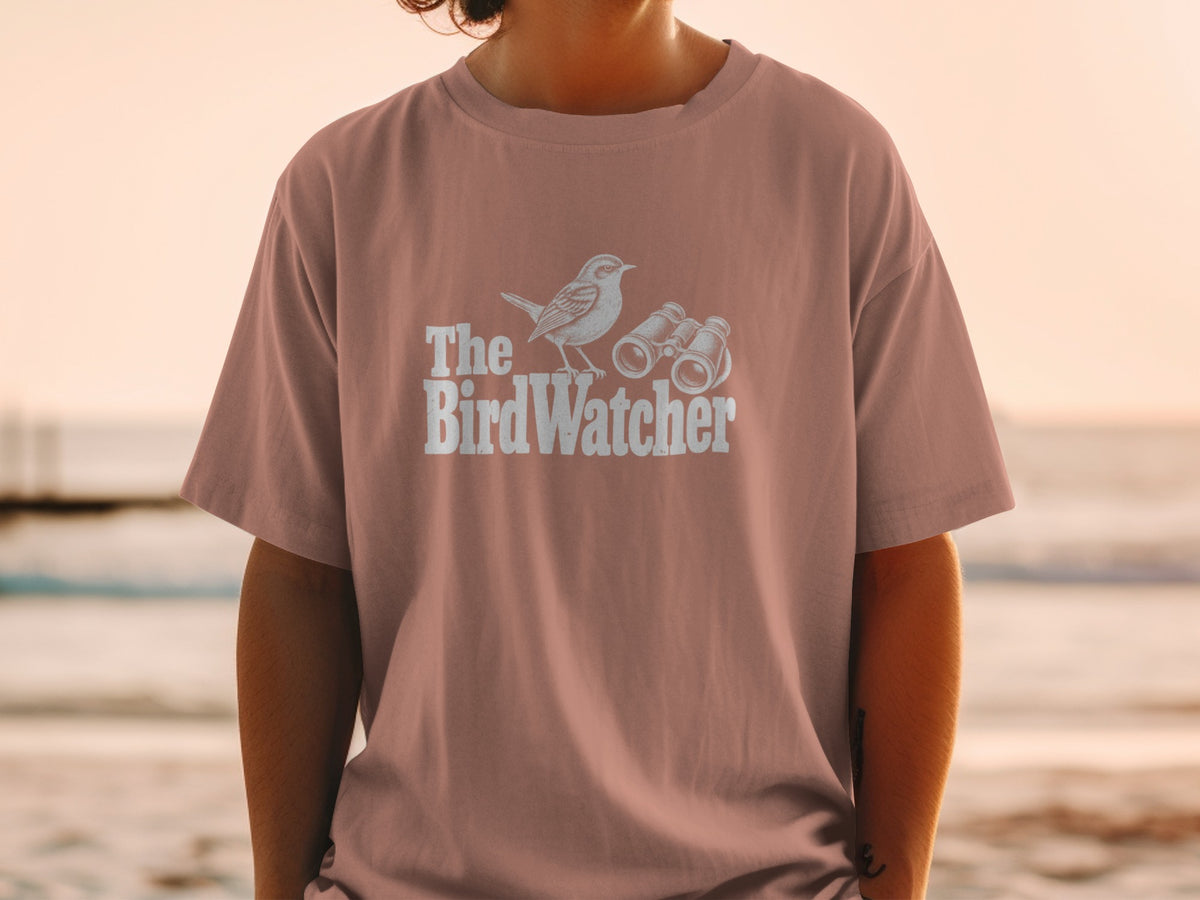 T-shirt with "The BirdWatcher" text, a bird, and binoculars graphic.