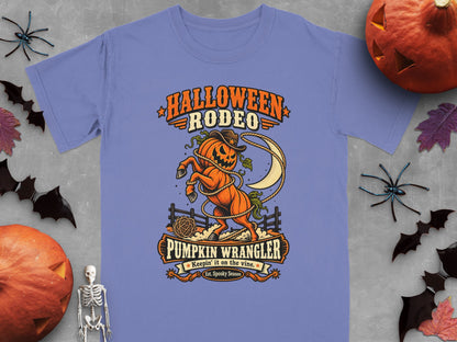 Halloween Rodeo Pumpkin Wrangler graphic on a periwinkle t-shirt.