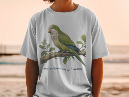 Green parrot on a branch with text "BIRDER: SEEN IN THE WILD YONDER".
