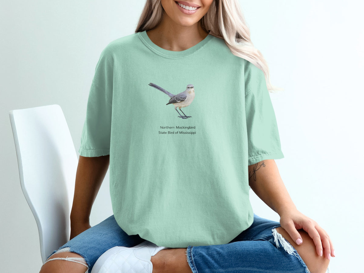 Mint green t-shirt with a Northern Mockingbird illustration and text.