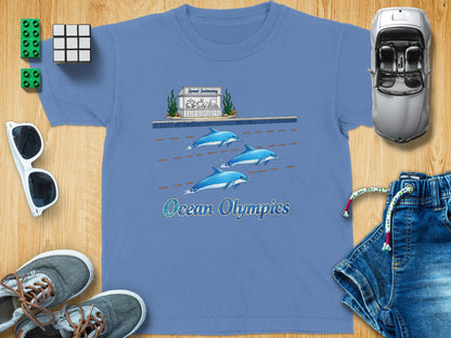 Blue t-shirt with dolphins racing in lanes under a "Speed Swimming" sign.