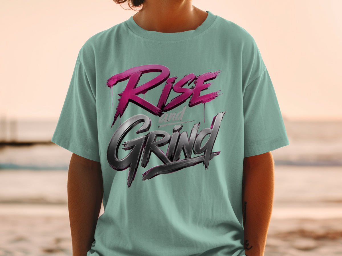 Teal t-shirt with "Rise and Grind" graphic in pink and metallic gray.