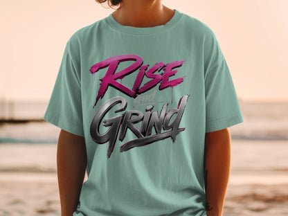 Teal t-shirt with "Rise and Grind" graphic in pink and metallic gray.