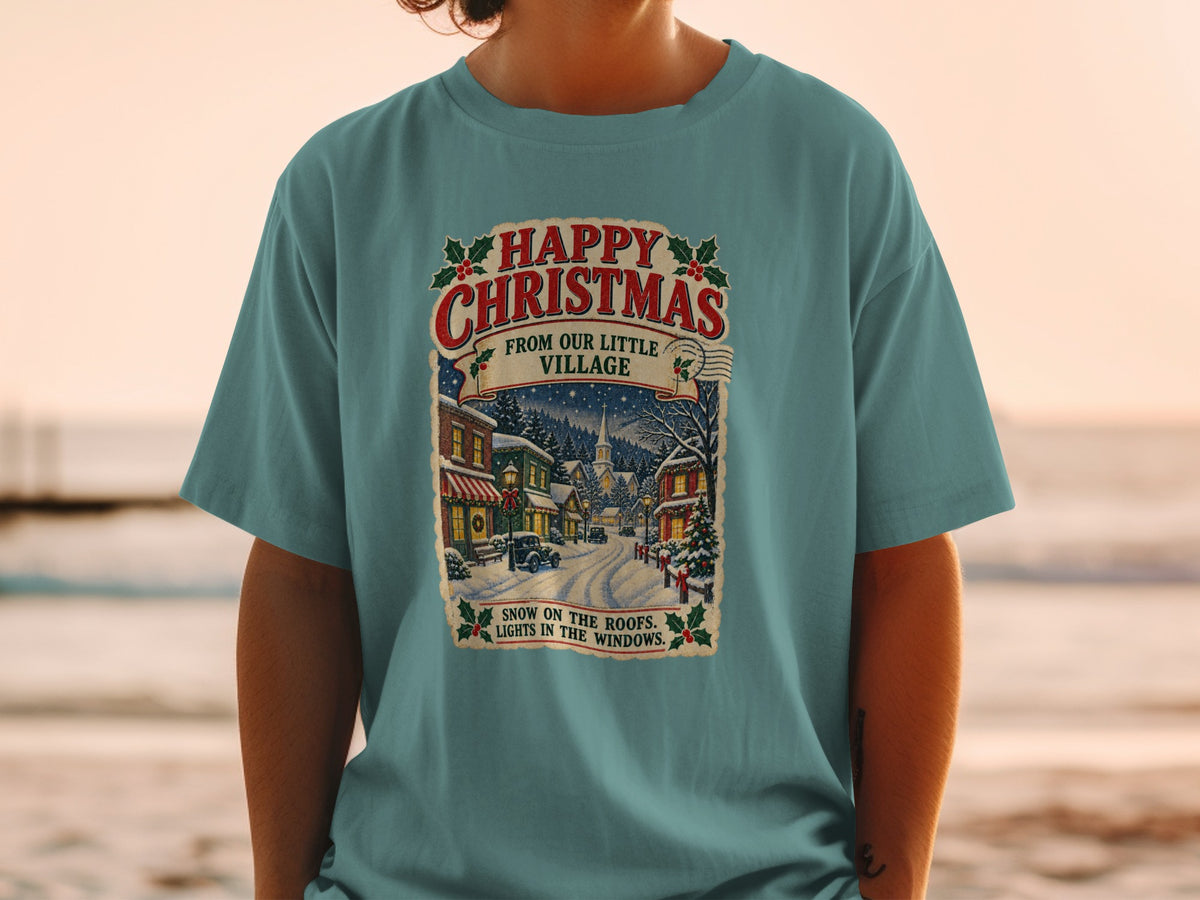 T-shirt with "Happy Christmas From Our Little Village" and a snowy street scene.