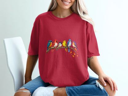 Red t-shirt with a watercolor design of six colorful birds perched on a branch.