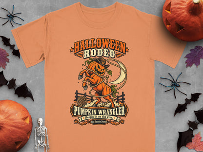 Orange t-shirt with "Halloween Rodeo Pumpkin Wrangler" graphic.