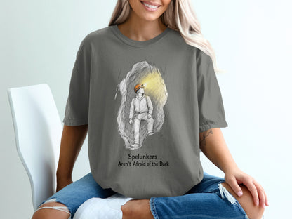 T-shirt graphic of a spelunker in a cave with text "Spelunkers Aren't Afraid of the Dark".