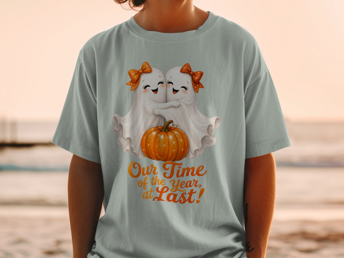 Two cute ghosts hug a pumpkin, with text "Our Time of the Year, at Last!"
