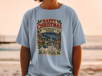 Light blue t-shirt with vintage Christmas village graphic and text.