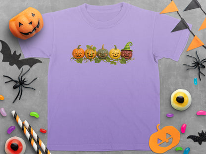 Lavender t-shirt with a row of five smiling pumpkins.