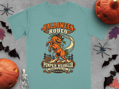 Halloween Rodeo Pumpkin Wrangler graphic with a pumpkin horse, lasso, and moon.