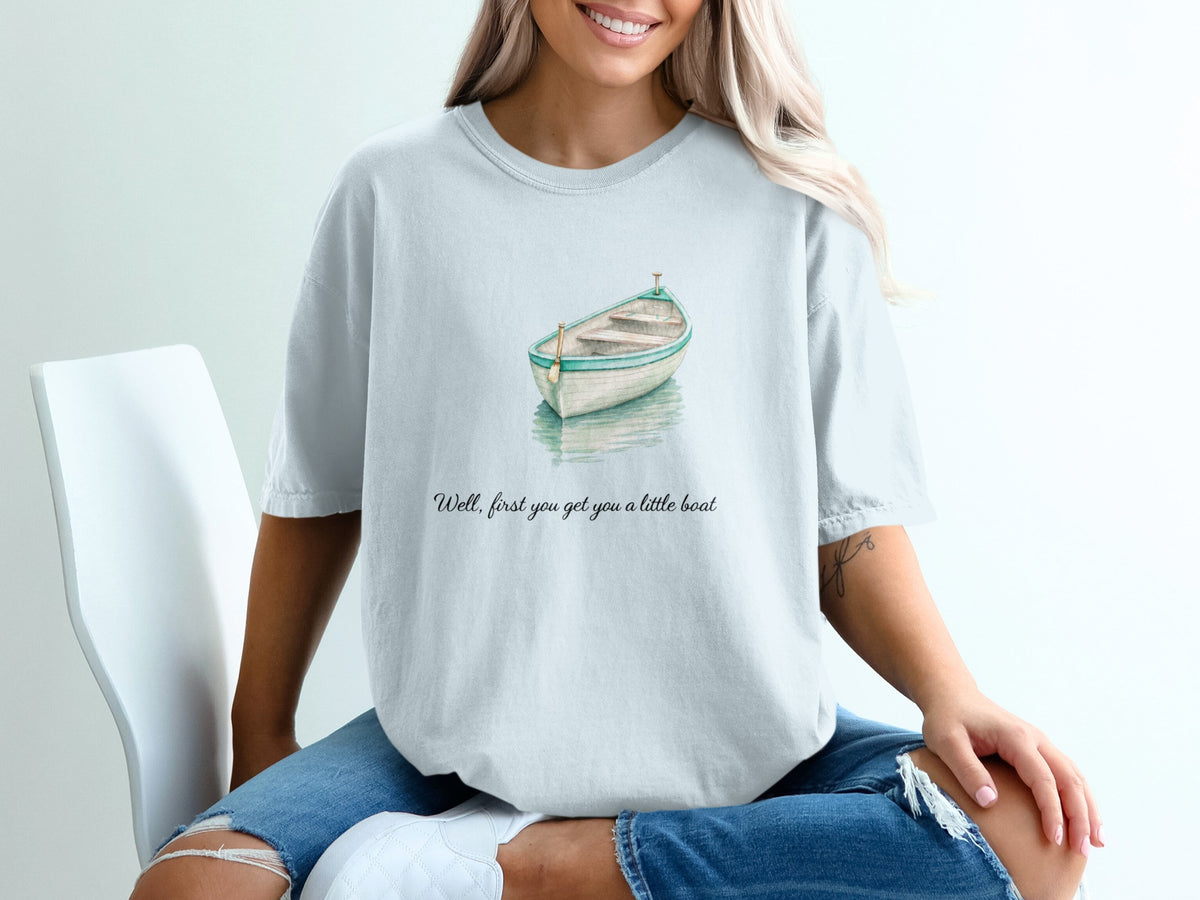 T-shirt with watercolor rowboat graphic and text "Well, first you got you a little boat."