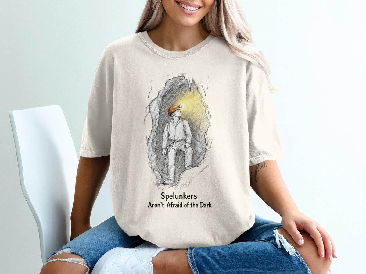 Sketch of a spelunker in a cave with text "Spelunkers Aren't Afraid of the Dark."
