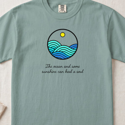 Teal t-shirt with circular ocean waves graphic and text "The ocean and some sunshine can heal a soul."