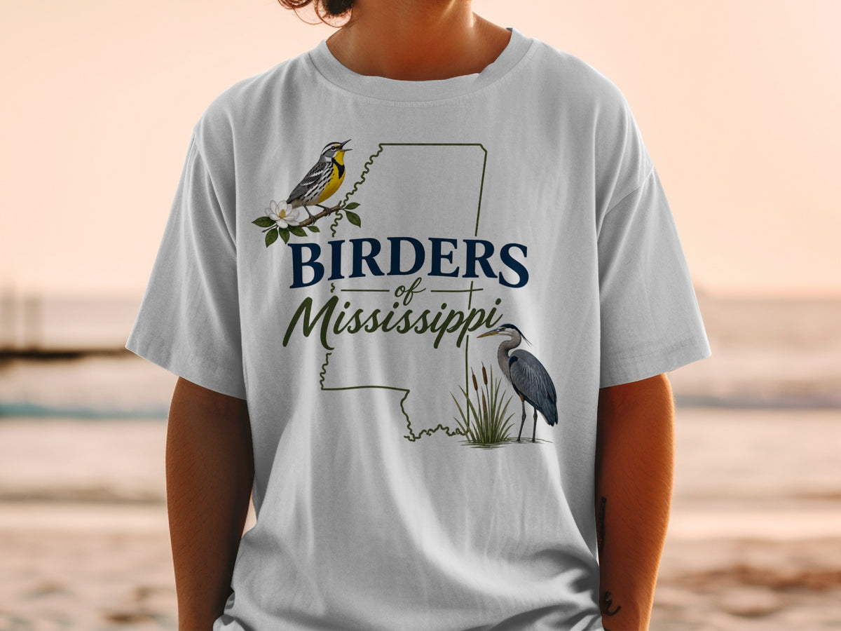 White t-shirt with "Birders of Mississippi" text, a yellow warbler and heron.