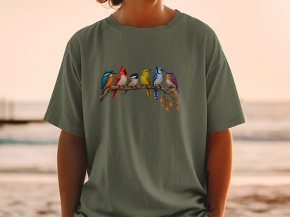 Six colorful birds perched on a branch with fall leaves design on green t-shirt.