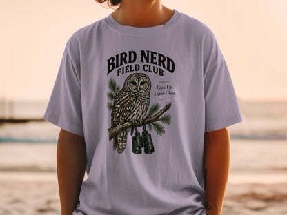 Lavender t-shirt with an owl, binoculars, and "Bird Nerd Field Club" text.