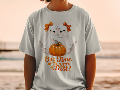 Two cute ghosts hug near a pumpkin with text "Our Time of the Year, at Last!".