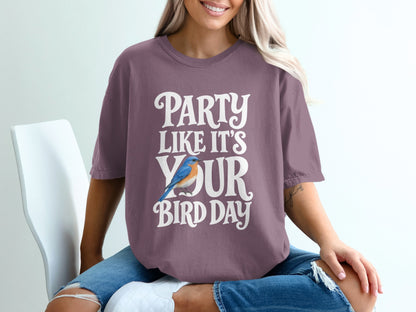Purple t-shirt with white text reading "PARTY LIKE IT'S YOUR BIRD DAY" and a blue bird graphic.