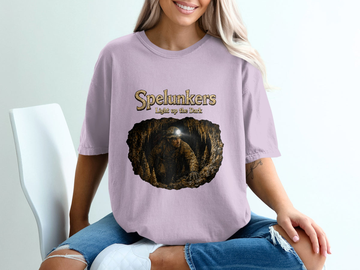 Spelunkers light up the dark t-shirt featuring a cave explorer in a cavern.