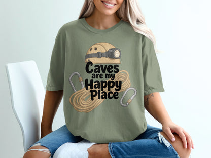 Green t-shirt with "Caves are my Happy Place" text and caving gear graphic.