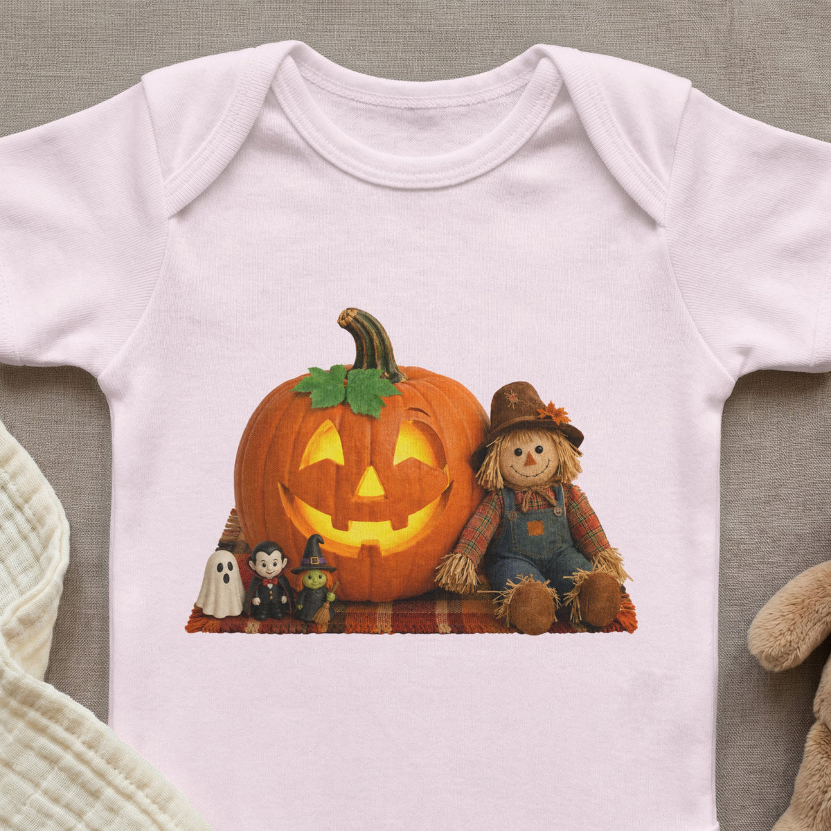 White baby onesie with Halloween characters: pumpkin, scarecrow, ghost, vampire, witch.