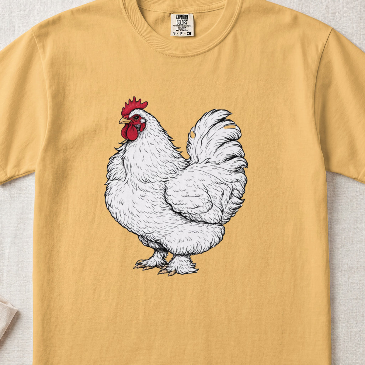 Gold t-shirt featuring a detailed illustration of a white rooster centered on the chest.