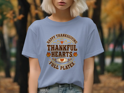 Light blue t-shirt with "Happy Thanksgiving Thankful Hearts Full Plates" text design.