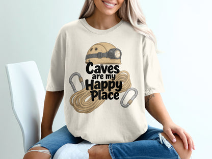 Cream t-shirt with caving helmet, rope, and carabiners, reading "Caves are my Happy Place".