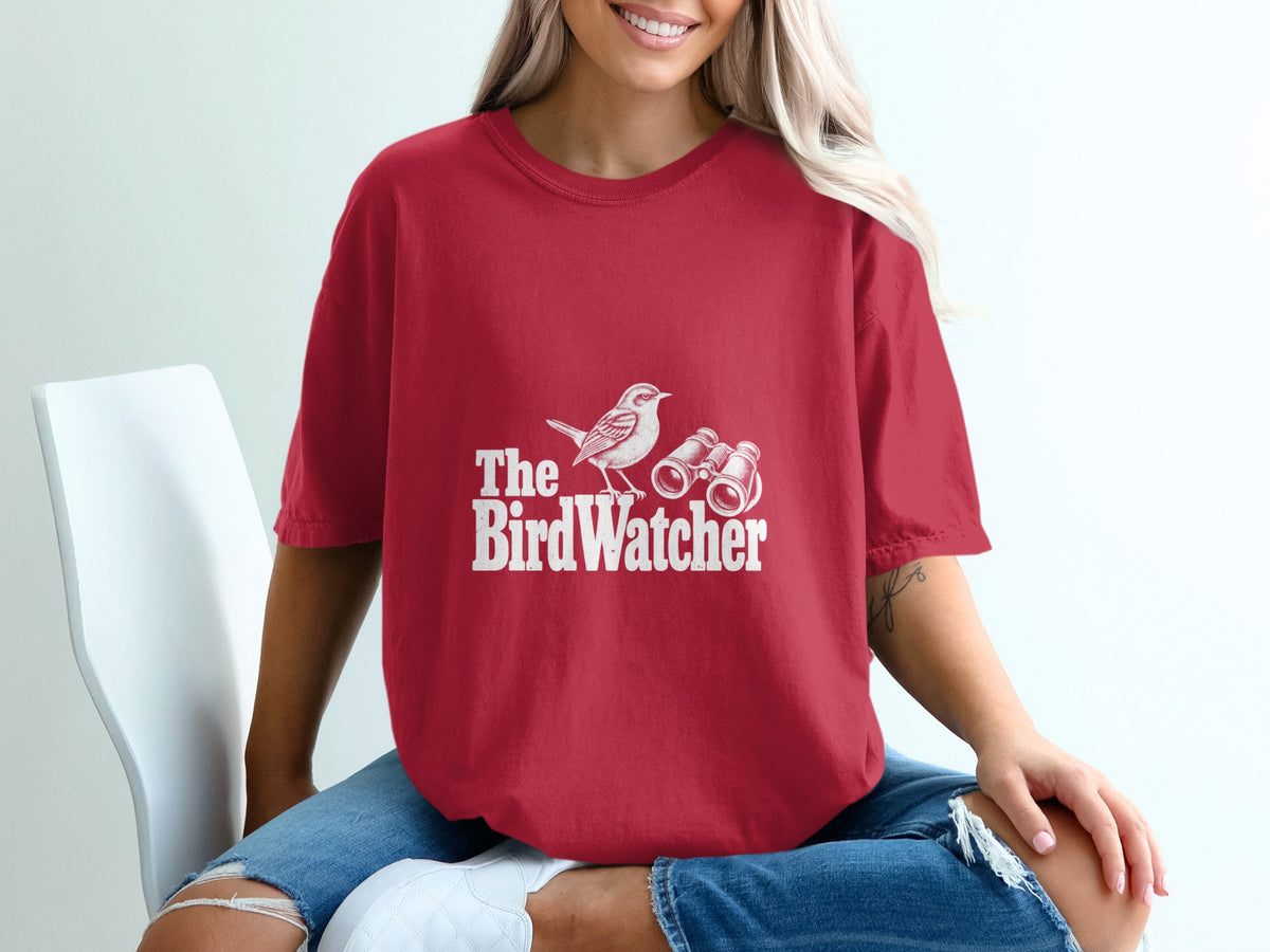 Red t-shirt with white graphic of bird and binoculars, reads "The BirdWatcher."