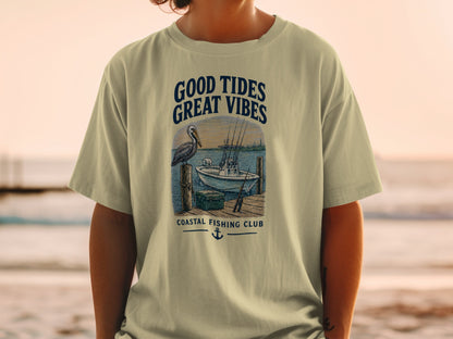 T-shirt graphic with text: Good Tides Great Vibes, pelican, boat, dock, and Coastal Fishing Club.