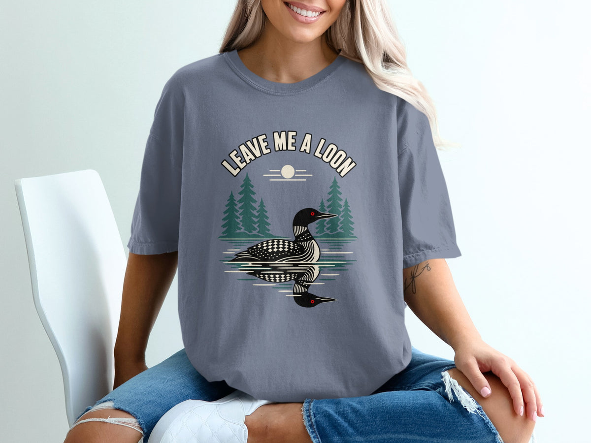 T-shirt with "Leave Me a Loon" text and a loon on water graphic.