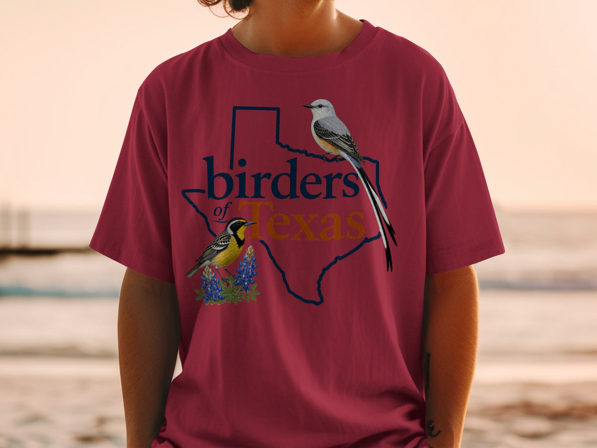 Maroon t-shirt with a Texas outline, birds, bluebonnets, and "birders of Texas" text.