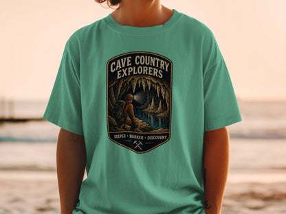 Cave Country Explorers graphic on a teal t-shirt with cave scene and text.