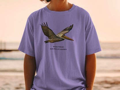Brown Pelican State Bird of Louisiana graphic on a purple t-shirt.