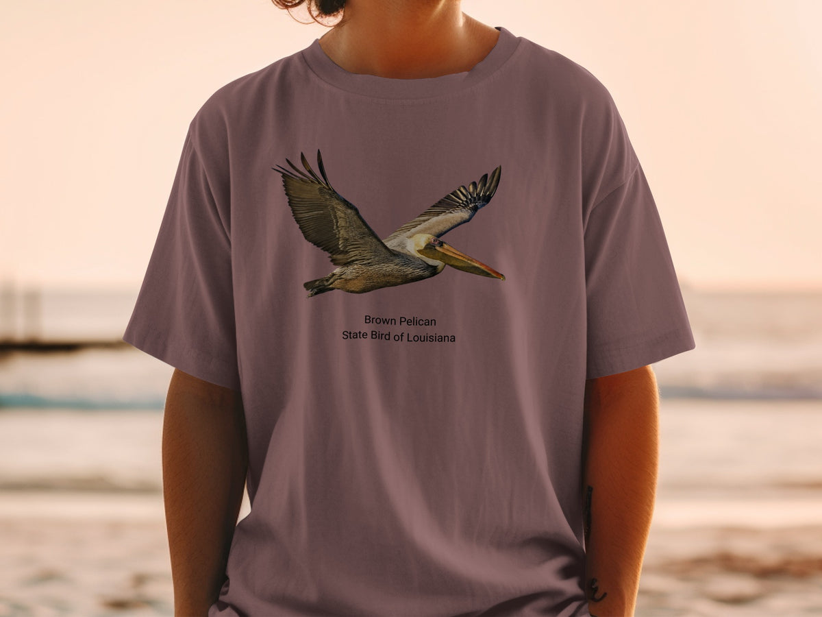 Brown Pelican, state bird of Louisiana, graphic on a mauve t-shirt.