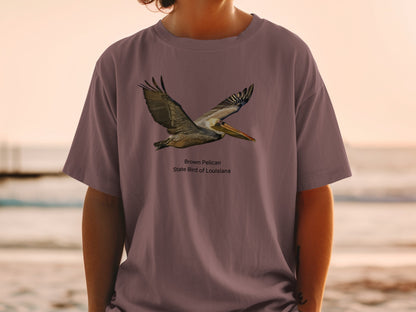 Brown Pelican, state bird of Louisiana, graphic on a mauve t-shirt.